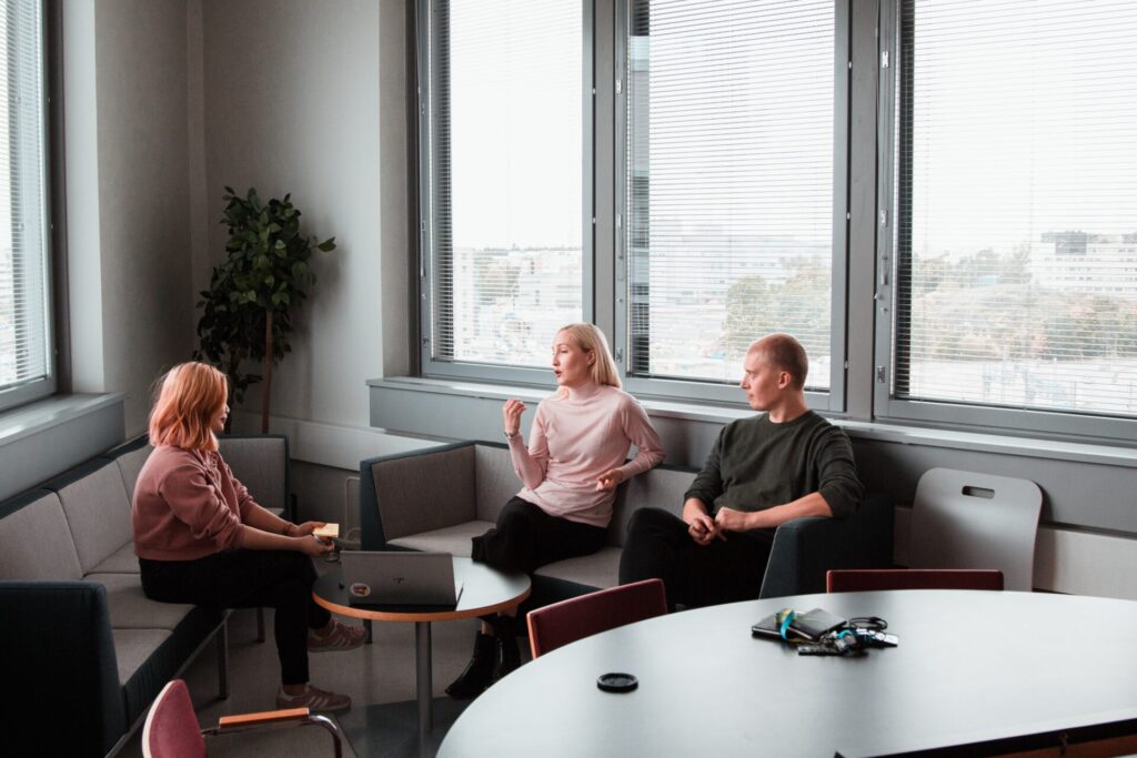 Group of 3 people having a conversation